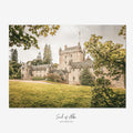 Fine art photograph of Cawdor Castle in the Scottish Highlands, framed by leafy trees and featuring its historic stone tower and courtyard.