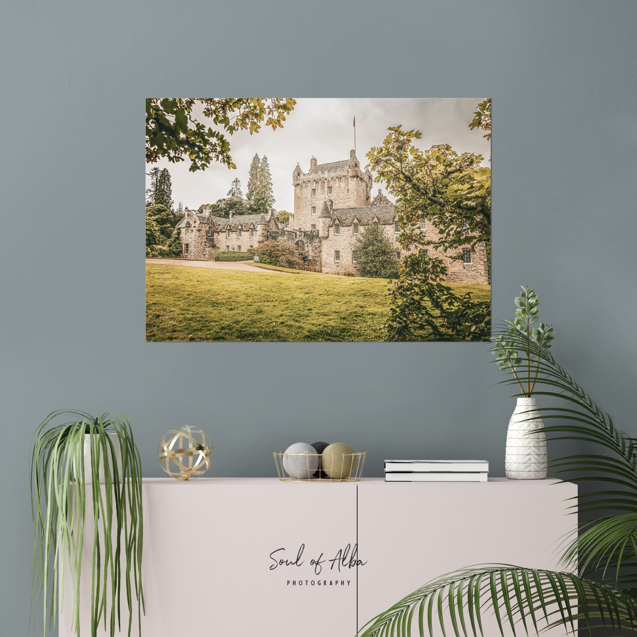Cawdor Castle fine art print displayed as elegant wall décor in a contemporary interior, showcasing the historic Highland castle framed by leafy trees.
