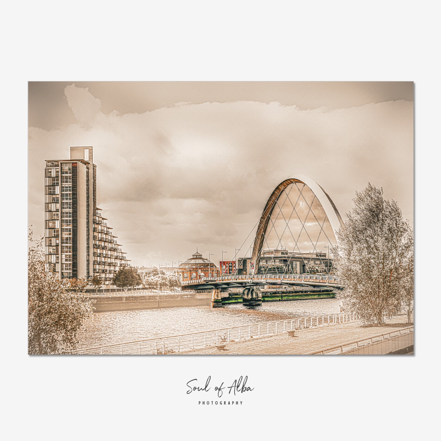 Fine art photograph of the Clyde Arc (Squinty Bridge) crossing the River Clyde in Glasgow, Scotland, beneath dramatic clouds and warm atmospheric light.