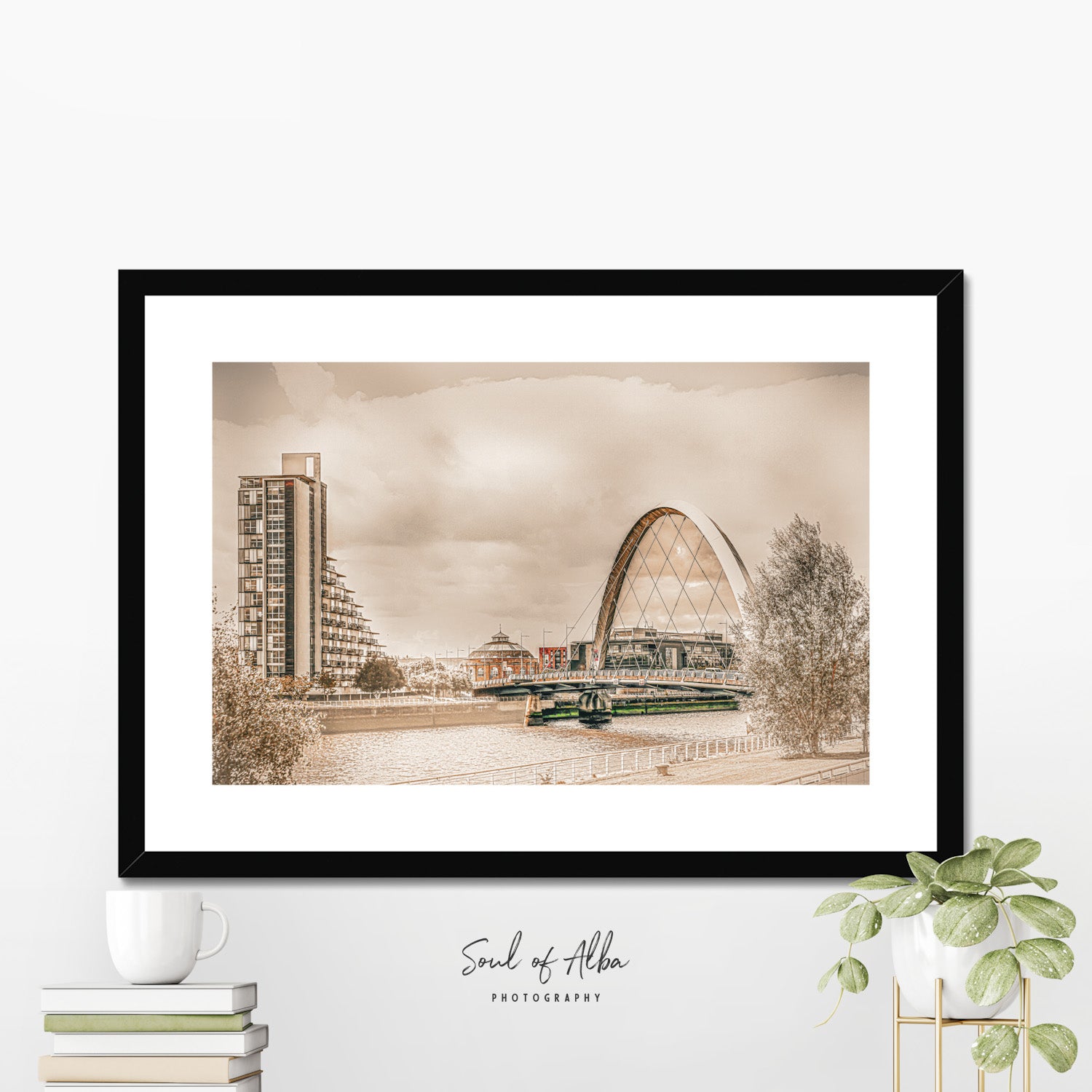 Fine art framed print of the Clyde Arc (Squinty Bridge) crossing the River Clyde in Glasgow, Scotland, beneath dramatic clouds and warm atmospheric light.