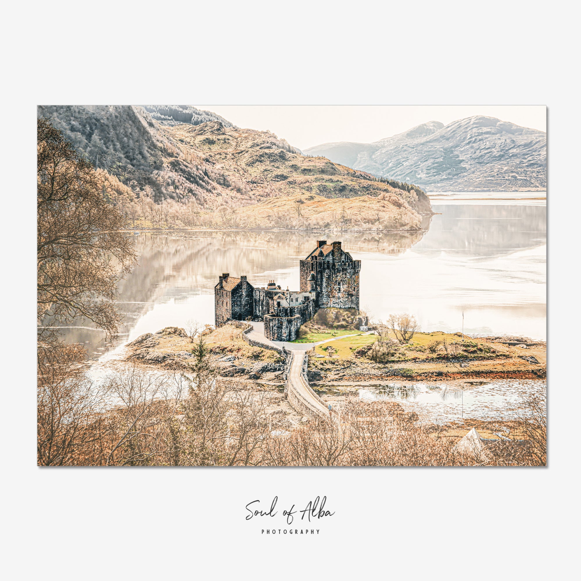 Fine art photograph of Eilean Donan Castle overlooking Loch Duich with the Scottish Highlands reflected in calm water.