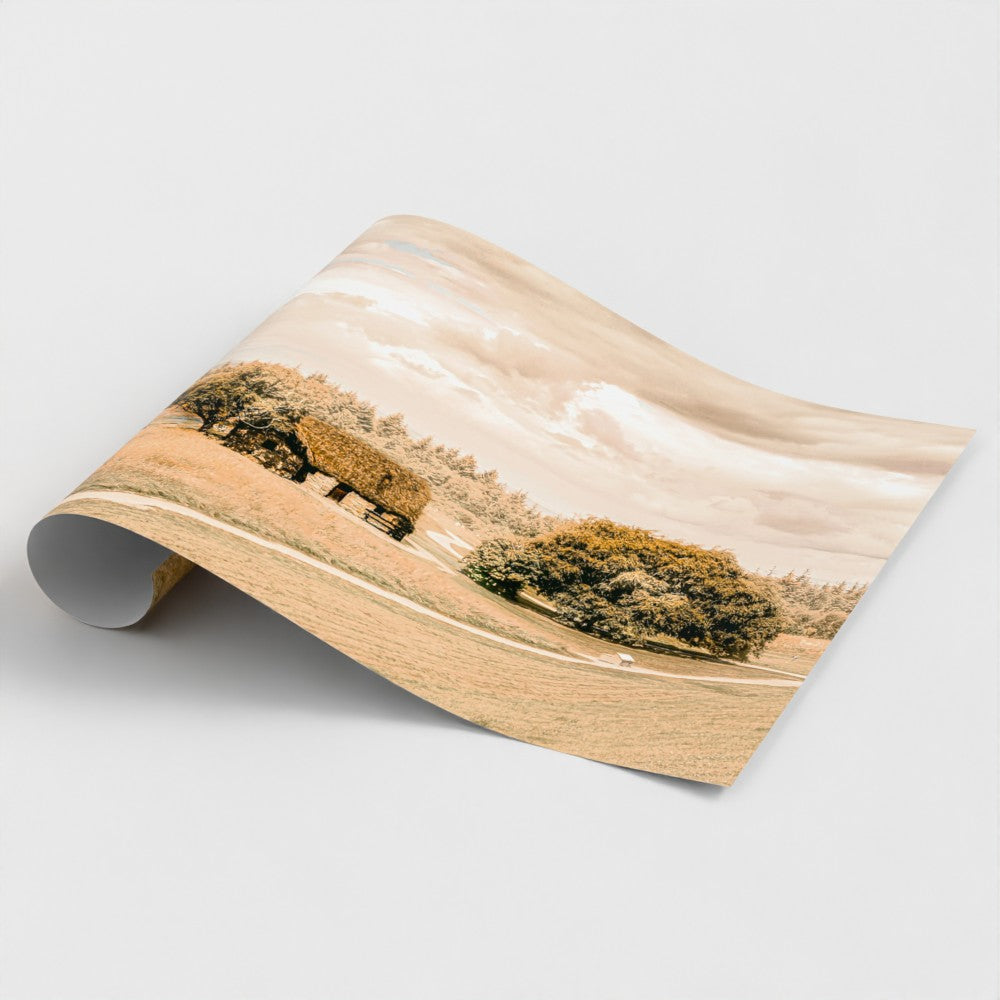 Rolled print with a landscape design featuring trees and a house.
