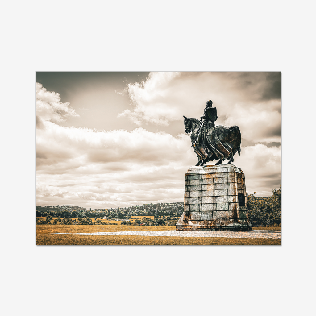 Fine art landscape photograph of the equestrian Robert the Bruce statue at Bannockburn Battlefield. The bronze monument stands resolute against a dramatic sweeping sky and the rolling hills of Stirlingshire. 