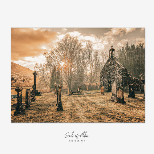 A square art print featuring a sepia-toned photograph of an old stone chapel and gravestones in a cemetery